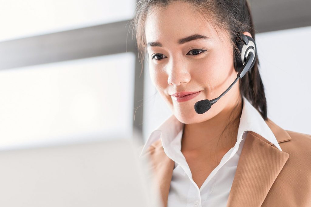 A Female Call Center Agent smiling with Satisfaction