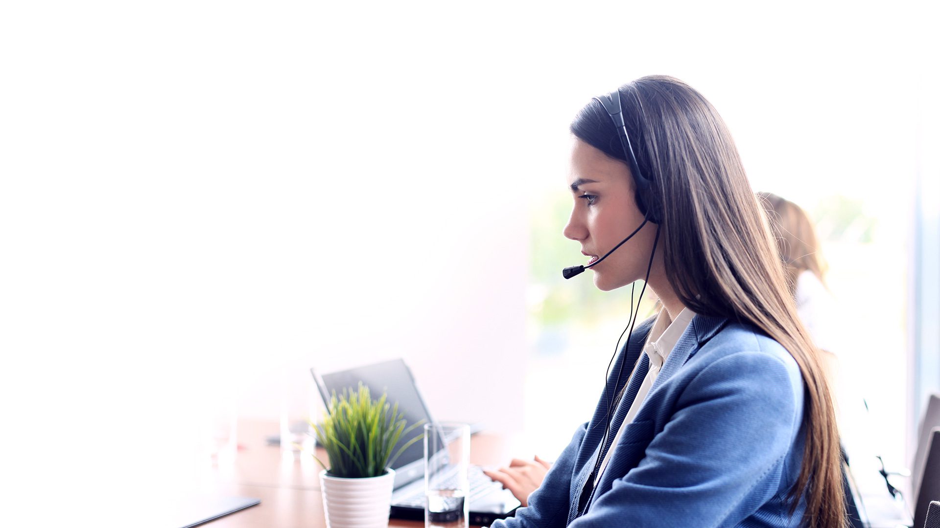 A woman with a headset taking calls in a call center