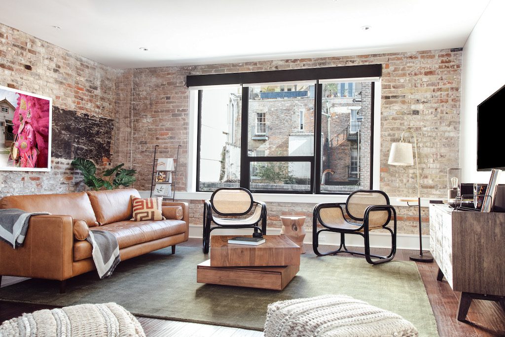 Lyric-New-Orleans-3-Bed-3-Bath-Apartment An Air BnB Interior with Brick Walls and a Glass Window