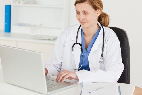 Woman in a White Coat and Stethoscope overseeing Medical Transcriptions