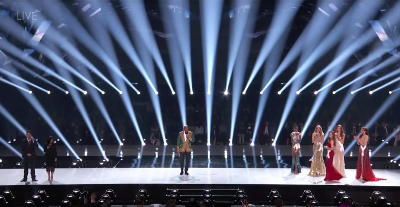 Steve Harvey onstage with Ms. Universe 2019 Contestants