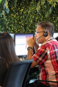 Male Outsourcing Employee wearing Glasses, Headset and Red Checkered Shirt