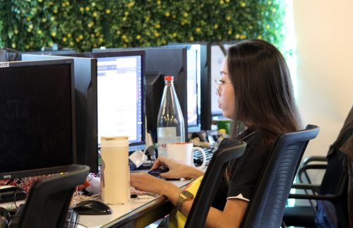 Female Social Media Marketing Employee in front of a Computer