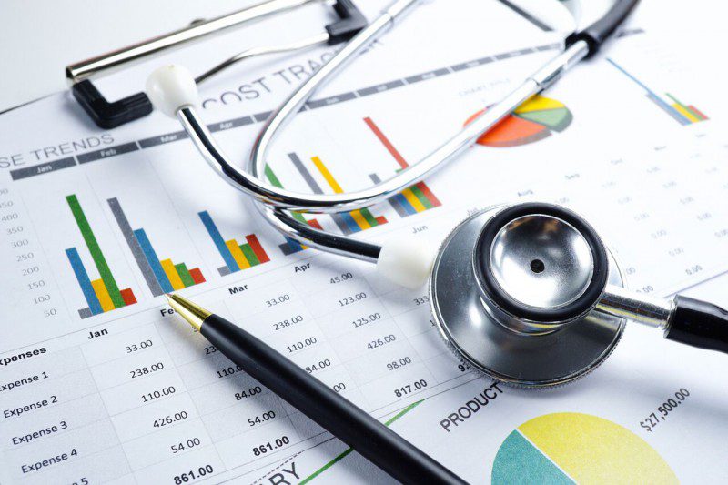 medical billing statement, stethoscope and paper